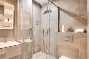 a shower with a glass door in a bathroom at Urban Flat 73 - Luxury Parisian Flat near Les Halles Rivoli in Paris
