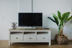 a white dresser with a tv on top at Sobre el mar con vistas a las Dunas de Maspalomas in San Agustin