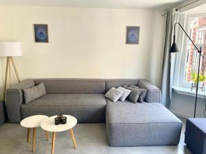 a living room with a couch and a table at Luxury Apartment With Free Parking in Ostend