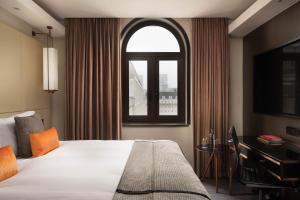 a hotel room with a bed and a window at Montcalm Royal London House, London City in London