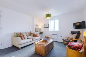 a living room with a couch and a table at Chester City Apartment in Chester