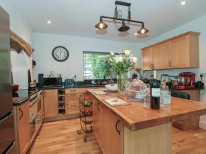 a kitchen with a counter and a clock on the wall at Brook Farm in Ringwood