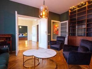 a living room with a table and chairs at Tyzenhauz Grand Apartaments in Krakow