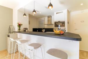 cocina con barra y taburetes en SELECT' - Appartement avec vue mer, à quelques metres du centre-ville avec parking - DOLCE VITA, en Le Lavandou