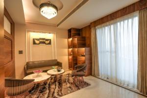 A seating area at Rj Hotel - Managed by Atithi House