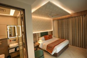 A bed or beds in a room at Rj Hotel - Managed by Atithi House