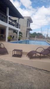 2 panche sedute accanto alla piscina di Cantinho Serrano a Serra de São Bento