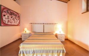 a bedroom with a bed and two night stands with lamps at Casa Giannini in Magliano in Toscana
