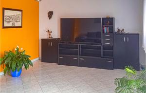 a living room with a large entertainment center at Gorgeous Home In Labin With Kitchen in Labin