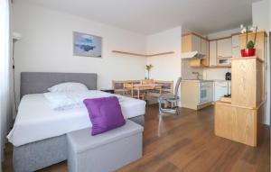 a bedroom with a bed and a kitchen with a table at Nice Apartment In Wels With Wi-fi in Wels