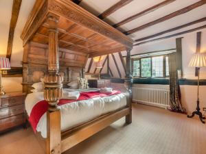a bedroom with a large wooden bed in a room at Ridge Hill Manor in Turners Hill