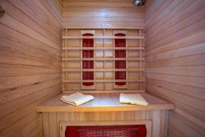 a wooden sauna with two towels sitting in it at Venus Holiday House with Pool in Banjole
