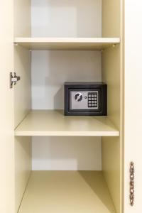 a small microwave in a kitchen shelf at Best Center Boutique Hotel in Baku