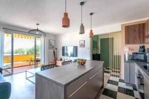 a kitchen with a large island in the middle of a room at * Le Floréal * Magnifique T3 vue Mer in Bandol