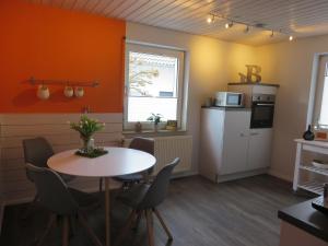 a kitchen and dining room with a table and chairs at Ferienwohnung Familie Buchner in Großheubach