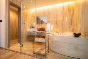a bathroom with a bath tub and a shower at ELITE LUXURY BOUTIQUE in Fier