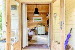 a door leading to a kitchen in a tiny house at Duck Lodge B&B with Hot Tub in Pyecombe