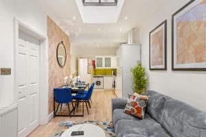 a living room with a couch and a dining room at Gorgeous 3-bedroom in London - Sleeps 8 in London