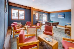 a waiting room with a pool table and chairs at Vacancéole - Le Borsat IV in Tignes
