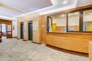 a waiting room with wood paneling and windows at Vacancéole - Le Borsat IV in Tignes