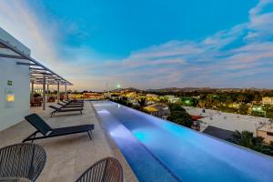 a swimming pool on the roof of a building at Cardinal Living San Jose del Cabo D-301 in San José del Cabo