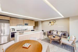 a kitchen and a living room with a table at Cardinal Living San Jose del Cabo D-301 in San José del Cabo