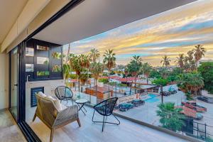 a room with a view of a pool and palm trees at Cardinal Living San Jose del Cabo D-301 in San José del Cabo
