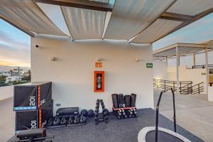 a fitness room with a gym with weights at Cardinal Living San Jose del Cabo D-301 in San José del Cabo