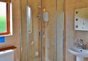 a bathroom with a shower and a sink at Finest Retreats- Little Dunley - Oaktree Cottage in Bovey Tracey