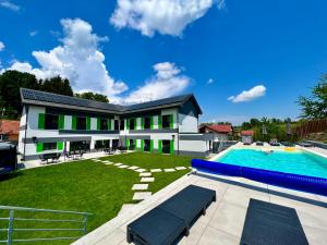 a large backyard with a swimming pool and a house at HELIOS Boutique Hotel in Săcele