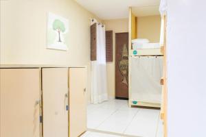 a room with cabinets and a room with a bathroom at Makeba Hostel in Pipa