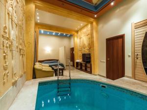 a large swimming pool in a room with a house at Cron Hotel in Moscow