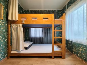 a bedroom with two bunk beds in a room at Greenday Guesthouse in Jeju