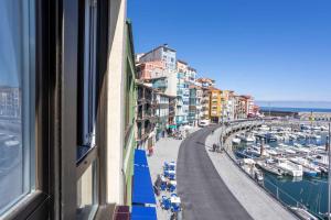 a view from a window of a marina with boats at Old Port, apartamento con vistas al puerto in Bermeo