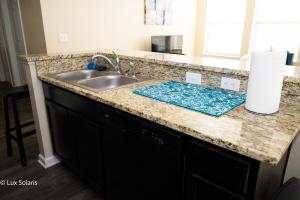 a kitchen counter top with a sink and a counter top at Luxury 3 Bedrooms with King bed Downtown Indy in Indianapolis