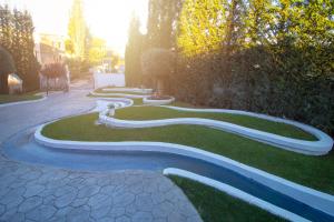 a winding path in a garden with trees and bushes at ELITE LUXURY BOUTIQUE in Fier