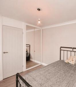 a bedroom with a bed and a closet and a door at Sam’s Retreats in Broomfield