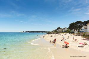 a group of people on a beach with the ocean at Douillette maison de ville à Carnac in Carnac