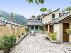 a patio of a house with a fence at Maison au centre du village, cour privative, au calme, Wi-Fi, cheminée, idéale pour familles. - FR-1-401-234 in Cauterets