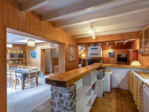 a kitchen with a counter and a dining room at Maison au centre du village, cour privative, au calme, Wi-Fi, cheminée, idéale pour familles. - FR-1-401-234 in Cauterets +10 photos