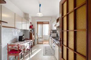 a kitchen with a table and a table and a door at Vanna House in Saint Vincent