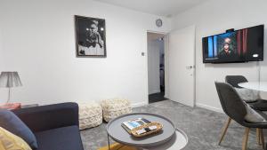 a living room with a couch and a table at Cozy Urban Oasis: Stylish One Bedroom Flat on Old Compton Street in London