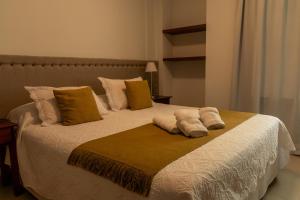 a bedroom with a bed with two pillows on it at ALTA VISTA APART HOTEL in Reconquista