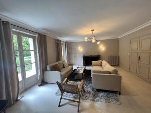 sala de estar con 2 sofás y chimenea en La Maison Des Pilotes - Circuit - Luxueux - 15 pers - Rêve au Mans, en Mulsanne