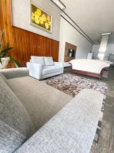 a living room with a bed and a couch at Hotel Cidade De Bauru in Bauru