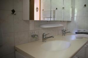 a bathroom with a white sink and a mirror at la Cibourg, Centre de vacances in Renan