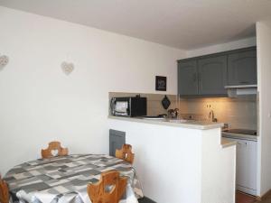 a kitchen with a table and a counter top at Studio Les Orres, 1 pièce, 4 personnes - FR-1-322-263 in Les Orres