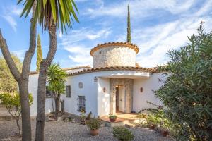 a house with a tower on the top of it at Villa Dolly in Calonge