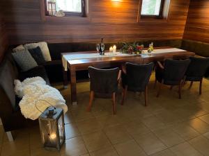 a dining room with a wooden table and chairs at Wellness Villa Liptov in Žiar