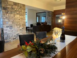 a dining room with a table with a bottle of wine at Wellness Villa Liptov in Žiar